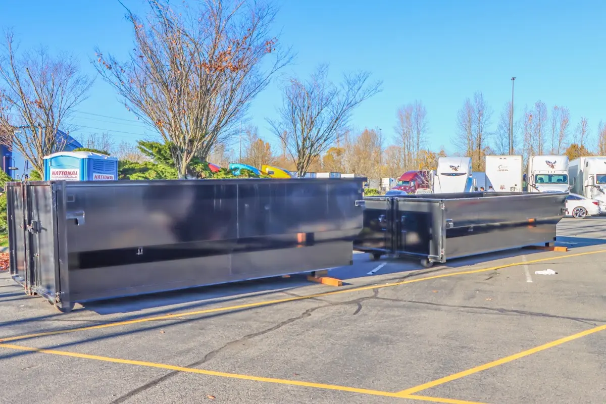 Professional dumpster rental service with roll-off container on residential driveway in Roswell